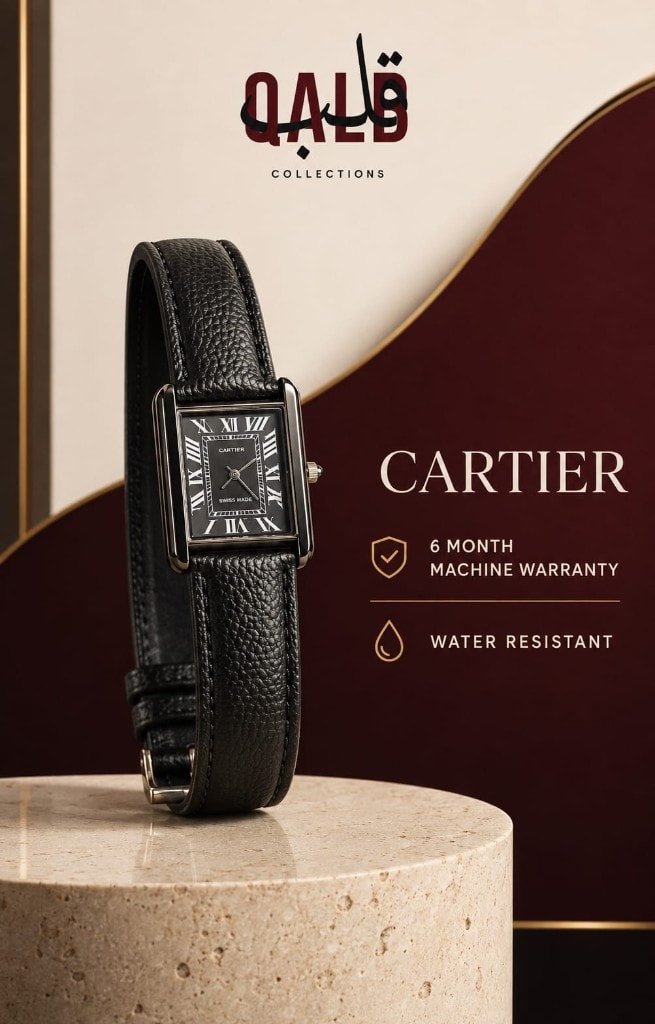 Cartier Tank rectangular watch with gold-tone case and black dial on a cream stone plinth
